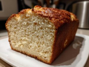 A close-up view showing the fluffy, moist interior crumb of a freshly baked beer bread loaf with a golden-brown crust.
