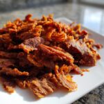 Close-up of thinly sliced, richly seasoned meat ready for homemade doner kebab.
